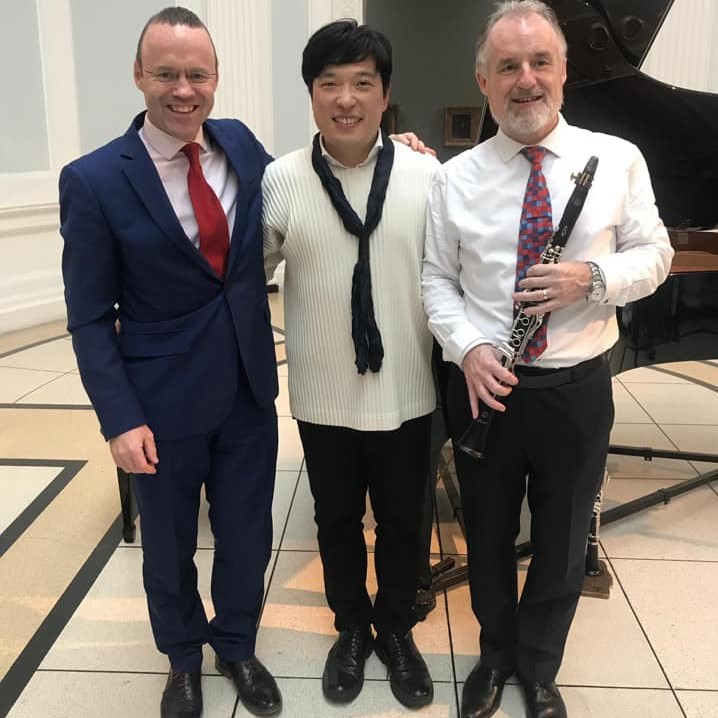 Sean Roe, Paul Roe, and Seho Lee posing for a photo post-concert